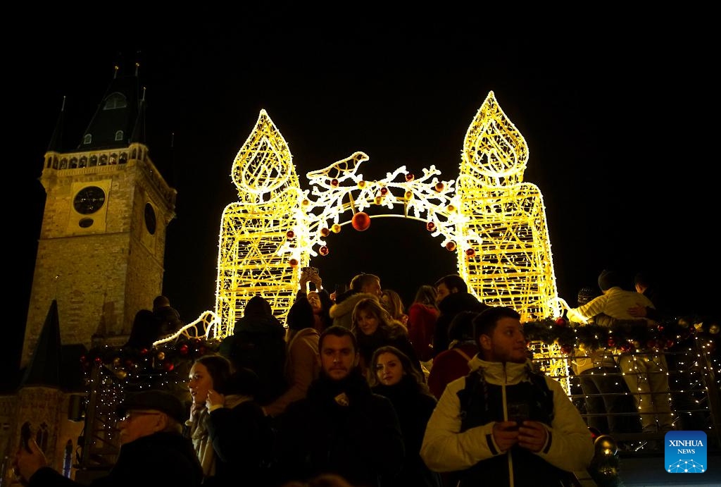 People are seen in front of a light installation at a Christmas market in Prague, the Czech Republic, on Dec. 12, 2023.(Photo: Xinhua)