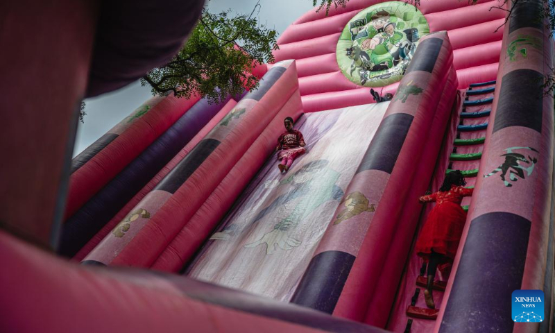 Children play on an inflatable slide at Uhuru Park in Nairobi, capital of Kenya, on Dec. 16, 2023. (Xinhua/Wang Guansen)