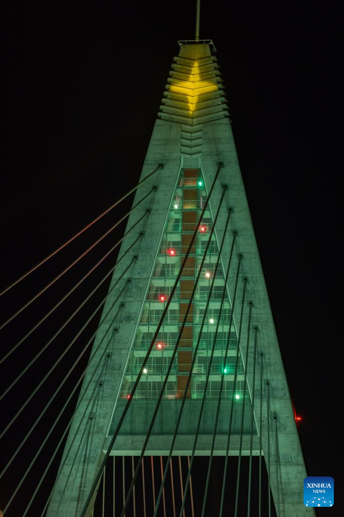 Christmas lights are pictured at the Megyeri Bridge over the Danube river in northern Budapest, Hungary on Dec. 17, 2023. (Photo by Attila Volgyi/Xinhua)