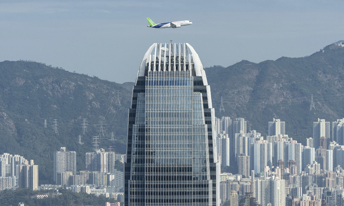 China's domestically developed C919 passenger aircraft flies over Victoria Harbour on December 16, 2023. Photo:VCG