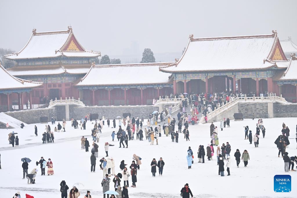Tourists visit the Palace Museum in snow in Beijing, capital of China, Dec. 13, 2023. China's meteorological authority on Wednesday renewed a yellow alert for blizzards, forecasting intense snowfall in the north of the country.(Photo: Xinhua)