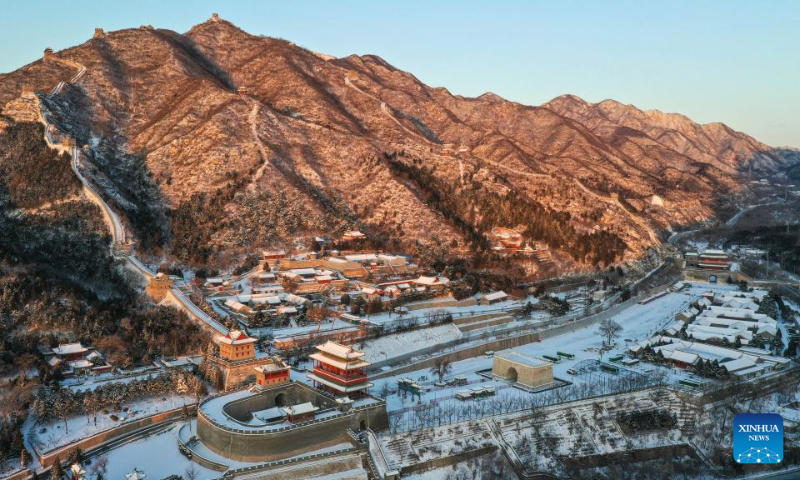 This aerial photo taken on Dec. 16, 2023 shows the snow scenery at the Juyongguan section of the Great Wall in the sunlight in Beijing, capital of China. (Xinhua/Chen Yehua)