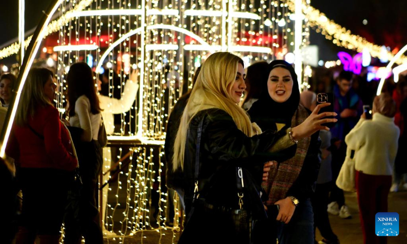 People visit a Christmas bazaar in Damascus, Syria, Dec. 16, 2023. (Photo by Ammar Safarjalani/Xinhua)