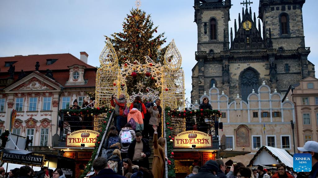 People are seen around a light installation at a Christmas market in Prague, the Czech Republic, on Dec. 12, 2023.(Photo: Xinhua)