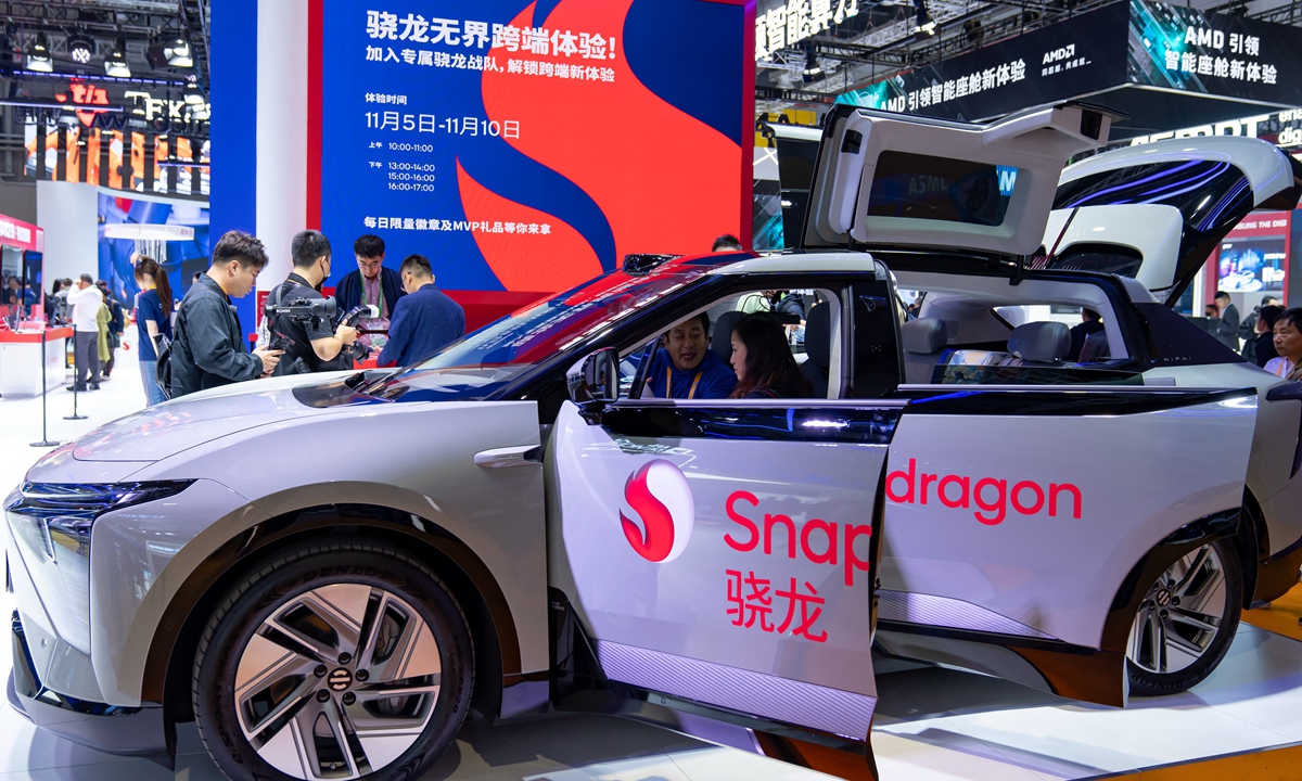 Visitors learn about smart cars loaded with Snapdragon chips at the 6th China International Import Expo in Shanghai on November 6, 2023. Photo: AFP