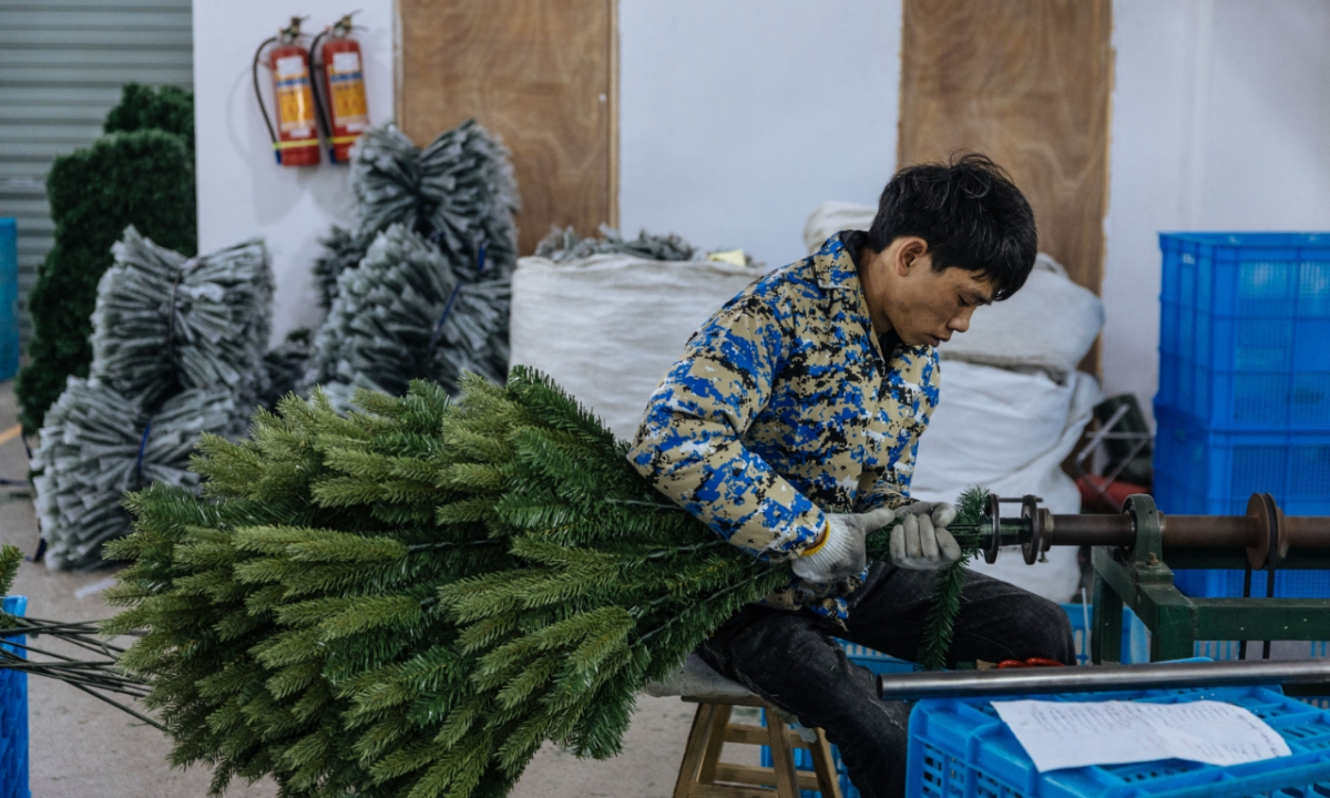 A worker manufactures Christmas trees in Yiwu, East China's Zhejiang Province on December 5, 2023. Photo: Li Hao/GT
