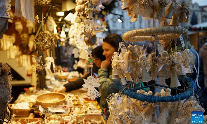 People select holiday decorations at a Christmas market in Prague, the Czech Republic, on Dec. 12, 2023.(Photo: Xinhua)