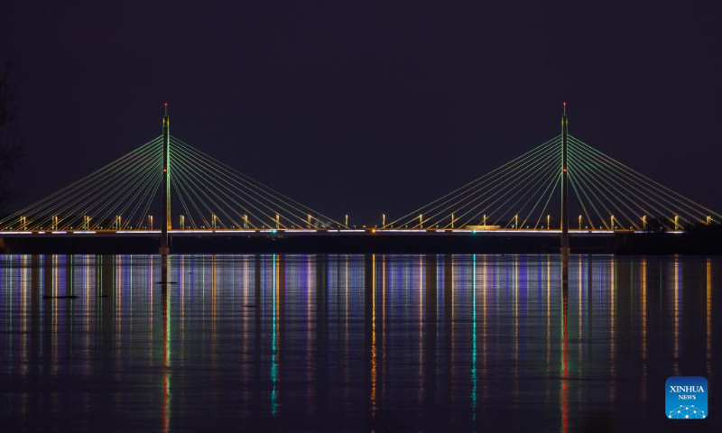 Christmas lights are pictured at the Megyeri Bridge over the Danube river in northern Budapest, Hungary on Dec. 17, 2023. (Photo by Attila Volgyi/Xinhua)