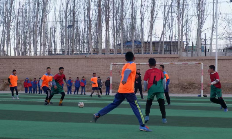 Students at Eksak Elementary School play a football game in Artux City, Northwest China's Xinjiang Uygur Autonomous Region. Photo: Xu Keyue/GT