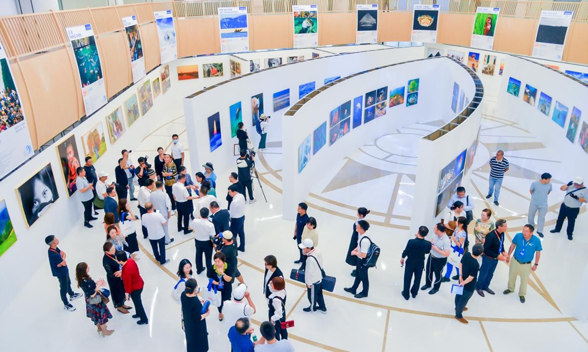 Visitors explore an exhibition at the Sanya International Photography Week. Photo: Courtesy of Sanya International Photography Week