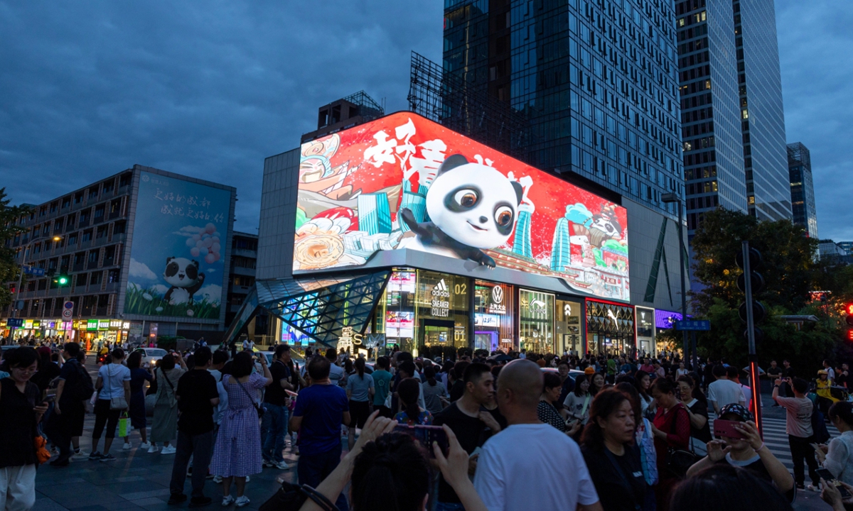 People walk past an advertisement for the Golden Panda Awards in Chengdu, Sichuan Province, on September 19, 2023. Photo: VCG
