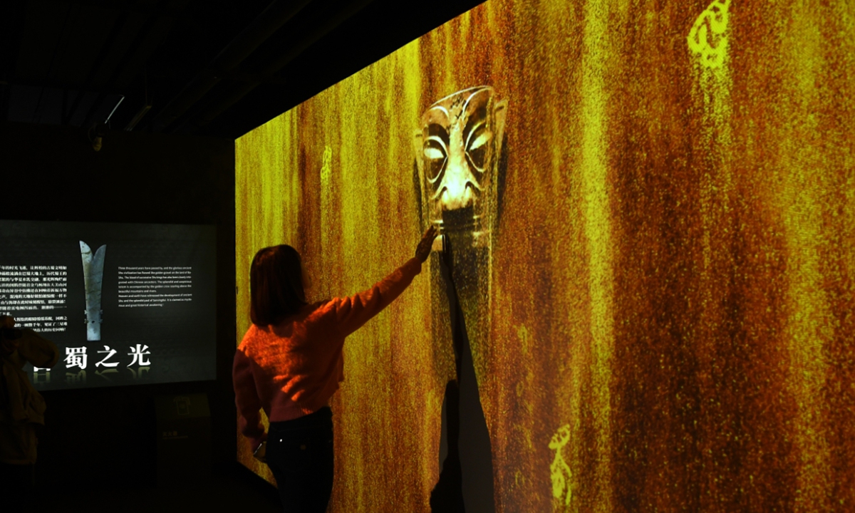 A visitor explores an immersive exhibition of Sanxingdui relics in Beijing on November 18, 2023.  Photo: VCG
