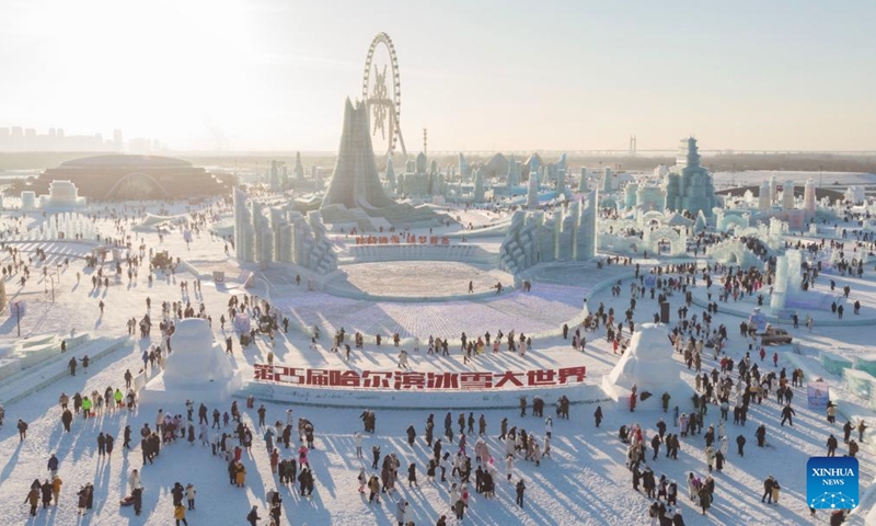 This aerial photo shows tourists visiting the Harbin Ice-Snow World in Harbin, northeast China's Heilongjiang Province, Dec. 18, 2023. The renowned Harbin Ice-Snow World opened to the public on Monday. Over 1,000 appealing ice and snow landscapes and sculptures have been built in the park for people to enjoy. The park aims to integrate arts, culture, performance, architecture and sports to showcase the charm of ice and snow.(Photo: Xinhua)