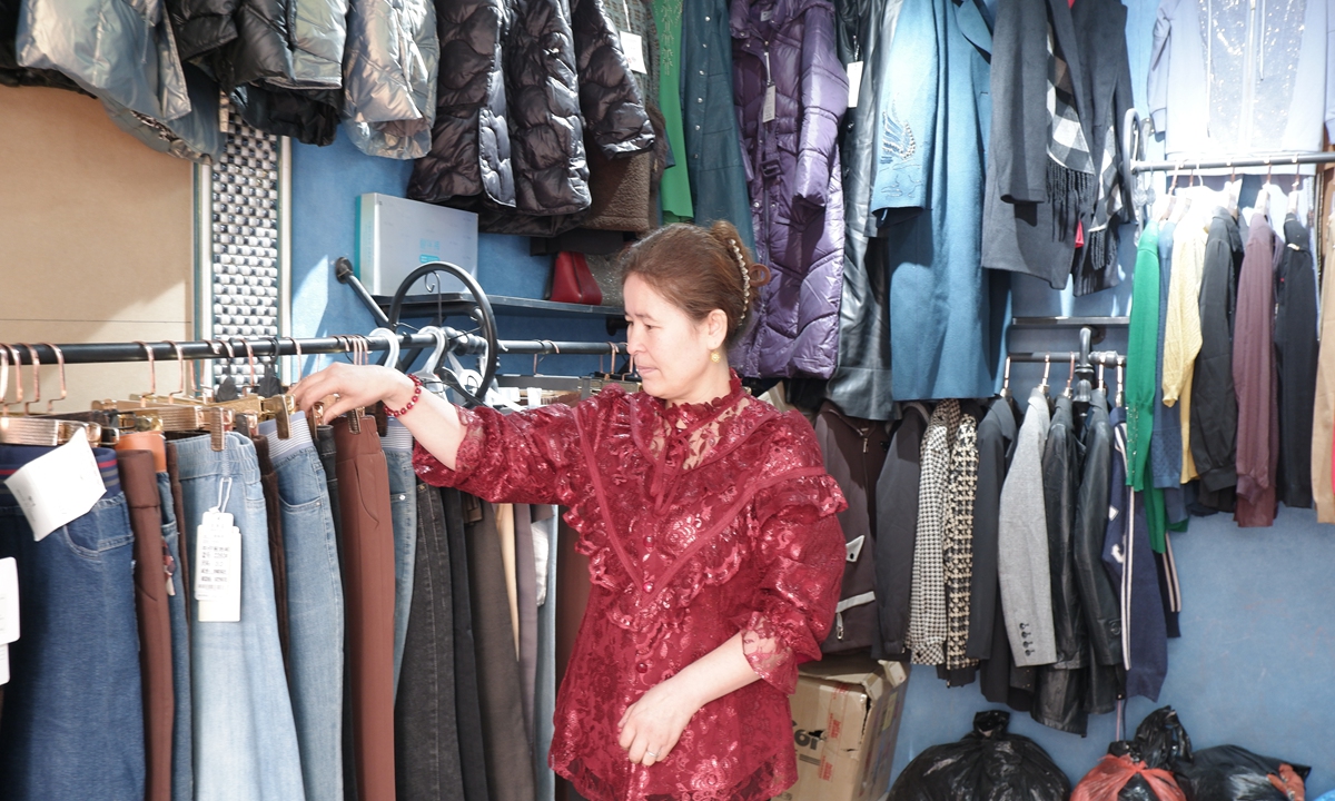 Buamyna Sadahmat, dressed in a red blouse adorned with layers of lace which she had made herself, is a renowned tailor at the Women's Entrepreneurship Street in Pishan Farm, located in Hotan Prefecture. Photo: Xu Keyue/GT
