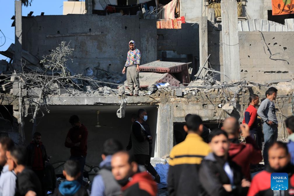 People inspect the damage after an Israeli airstrike in the southern Gaza Strip city of Rafah, on Dec. 19, 2023. The death toll of Palestinians from Israeli attacks in the Gaza Strip has risen to 19,667, and 52,586 others were wounded since Oct. 7, the Hamas-run Health Ministry said on Tuesday. （Photo: Xinhua)
