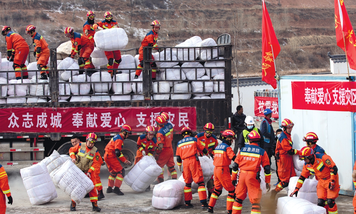 Firefighters carry earthquake relief supplies in Jishishan county, Northwest China's Gansu Province, on December 20, 2023. Photo: VCG
