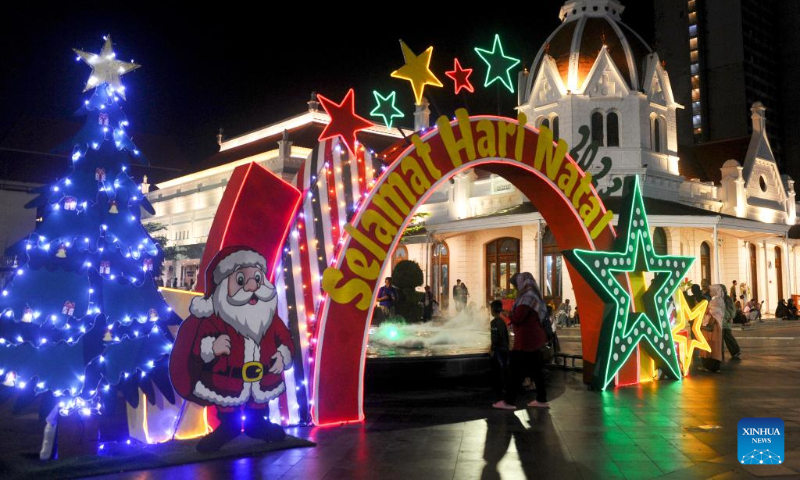 People view Christmas light show installations in Surabaya, East Java, Indonesia, Dec. 23, 2023. (Photo by Sahlan Kurniawan/Xinhua)