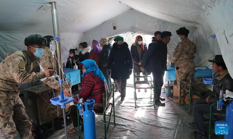 Soldiers provide medical services for people affected by the earthquake at a resettlement site in Shiyuan Township of Jishishan County, northwest China's Gansu Province, Dec. 20, 2023. The Chinese People's Liberation Army (PLA) and the People's Armed Police Force (PAPF) have deployed multiple rescue forces to quake-hit areas in response to a 6.2-magnitude earthquake that jolted northwest China's Gansu Province late Monday.(Photo: Xinhua)