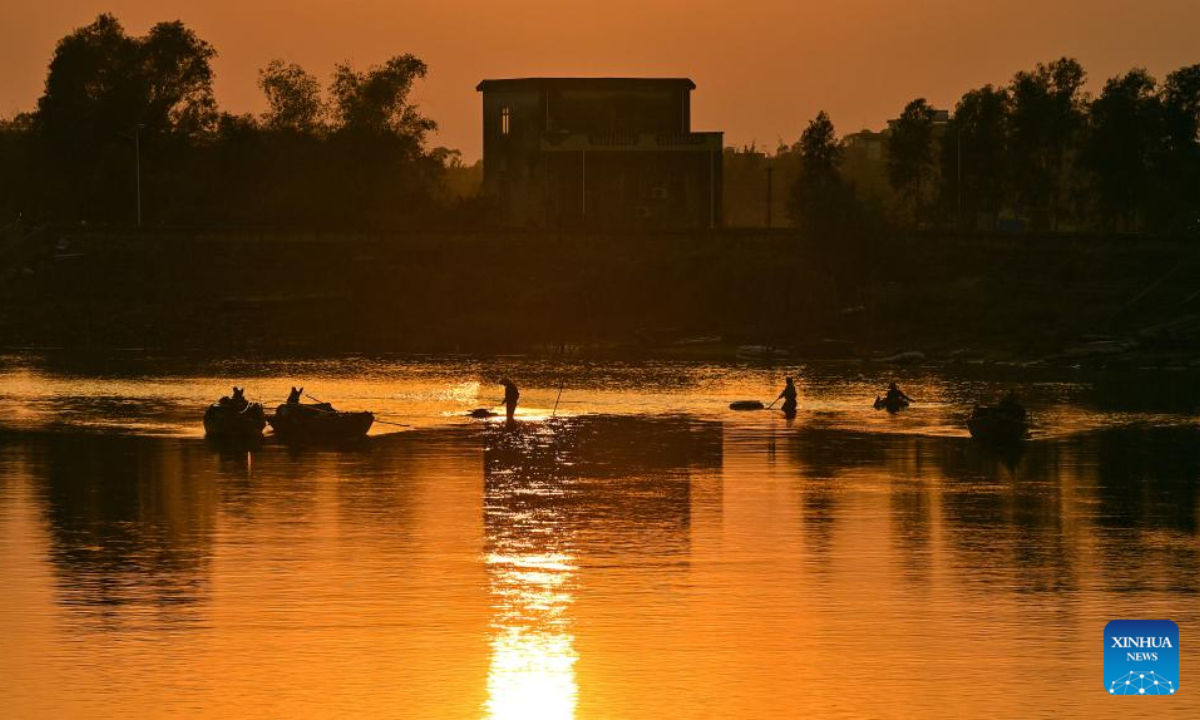 Villagers are seen busy at a tilapia pond in Lianzhou Town of Hepu County, south China's Guangxi Zhuang Autonomous Region, Dec 27, 2023. Photo:Xinhua