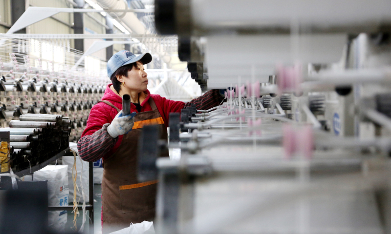 A worker is busy on the production line in a private enterprise in the Lianyungang Economic and Technological Development Area in Jiangsu Province on March 27, 2023. Photo: VCG