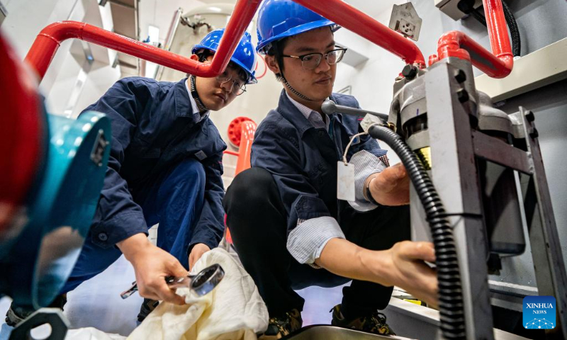 Staff members work at the Wudongde hydropower station on the border of Sichuan and Yunnan provinces in southwest China, Dec. 22, 2023. Wudongde hydropower station is a major national project to implement China's west-to-east power transmission program. (Xinhua/Hu Chao)