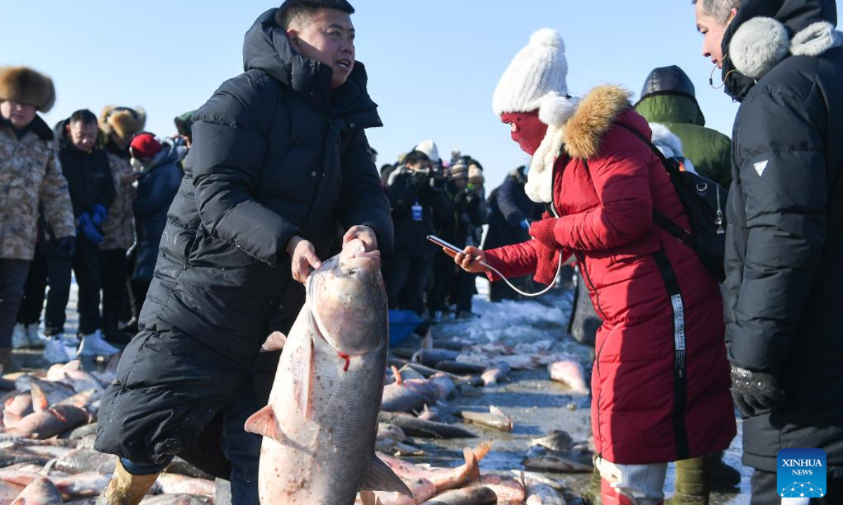 Tourists select fishes during a winter fishing-themed festival on the Chagan Lake in Songyuan City, northeast China's Jilin Province, Dec 28, 2023. Photo:Xinhua