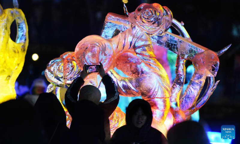 People visit the 50th Harbin ice lantern fair in Harbin, northeast China's Heilongjiang Province, Dec. 31, 2023. The ice lantern fair kicked off here on Sunday. (Xinhua/Wang Jianwei)