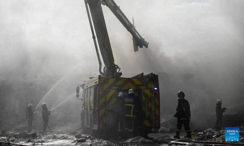 Firefighters work to extinguish a fire at a waste management complex in Maghtab, Naxxar, Malta, on Dec. 23, 2023. The waste management complex caught fire on Saturday morning. (Photo by Jonathan Borg/Xinhua)