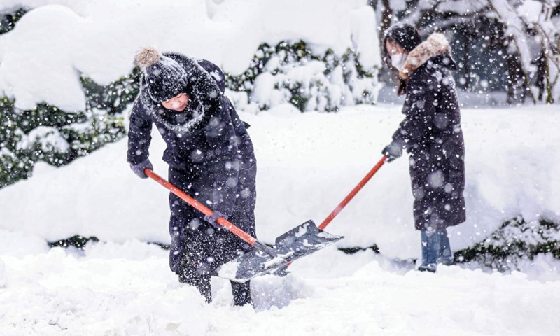 People clear snow on the road in Rongcheng, in Weihai, East China’s Shandong Province, on December 21, 2023. Photo: Xinhua