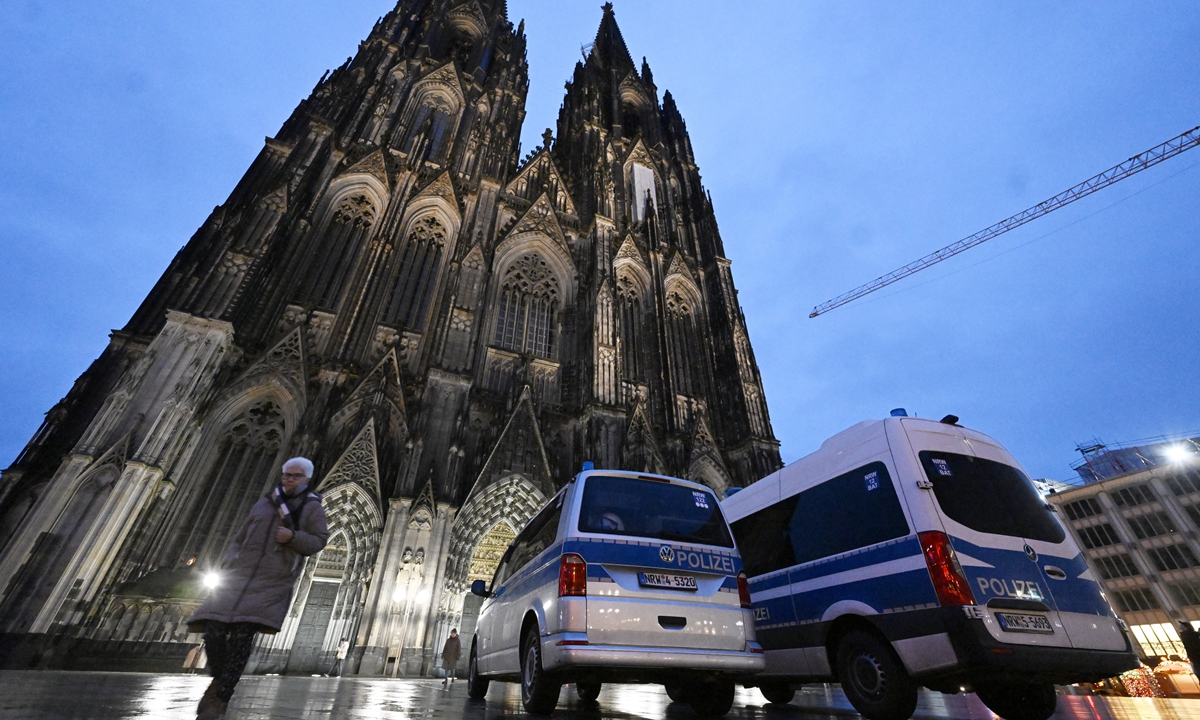 German police officers at the entrance to Cologne Cathedral control the start of early mass on December 24, 2023. Due to indications of a planned attack, the local police have stepped up security measures. Neither police agency specified the threat, but the German news agency dpa said authorities were responding to signs of a possible attack by 