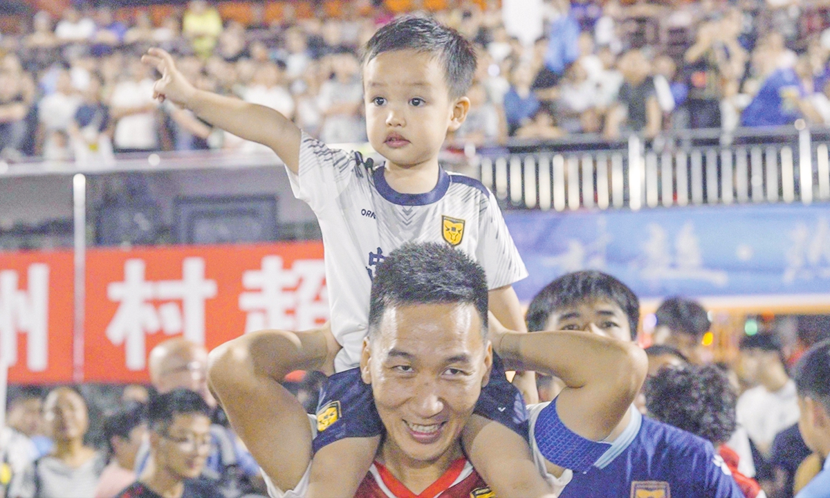 Village Super League top scorer Dong Yongheng and his child Photo: Li Jieyi/GT