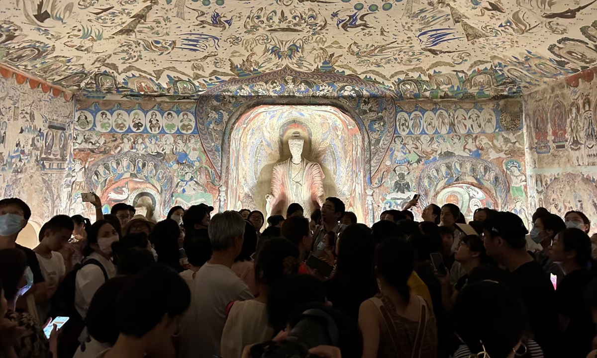 Visitors explore the Convergence of Civilizations, Dunhuang on the Silk Road Exhibition at the China National Silk Museum in Hangzhou, East China's Zhejiang Province. Photo: Courtesy of the China National Silk Museum