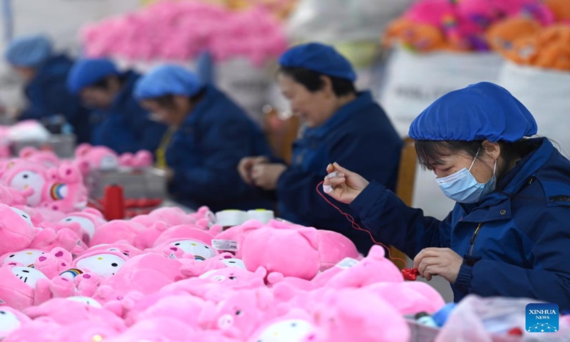 Staff members of Ankang Heng'an Toy Ltd., work at a workshop in Ankang, northwest China's Shaanxi Province, Dec. 21, 2023. (Xinhua/Zou Jingyi)