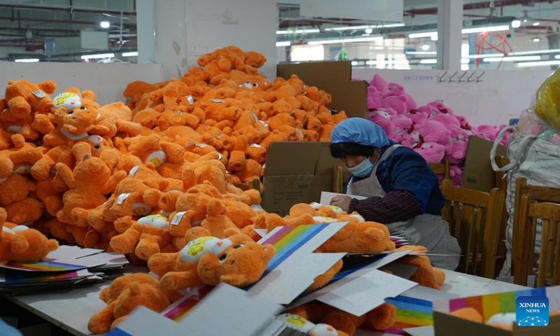 A staff member of Ankang Heng'an Toy Ltd., works at a workshop in Ankang, northwest China's Shaanxi Province, Dec. 21, 2023. (Xinhua/Wu Hongbo)