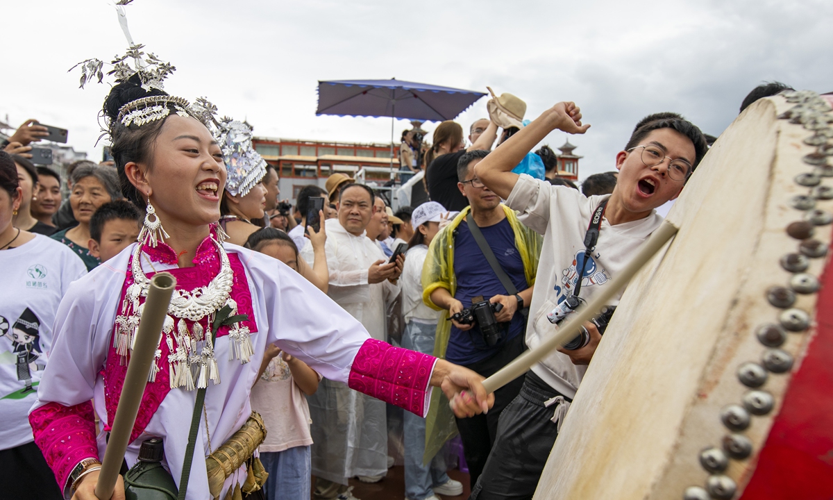 An ethnic Dong woman plays a drum during a soccer match in Rongjiang county, Guizhou Province, on June 23, 2023. Photo: IC
