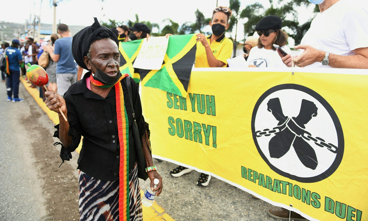 People calling for slavery reparations protest outside the entrance of the British High Commission during the visit of the Duke and Duchess of Cambridge in Kingston, Jamaica on March 22, 2022. Photo: AFP