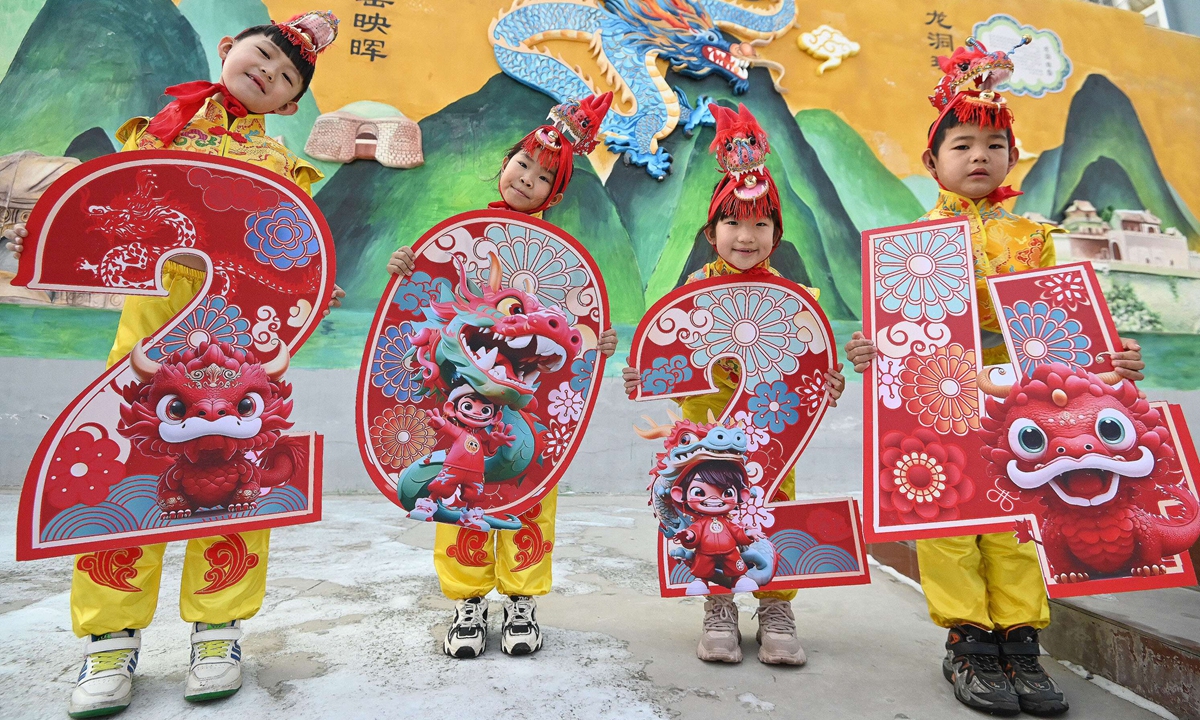 Students at a primary school in Handan, North China's Hebei Province, hold the 