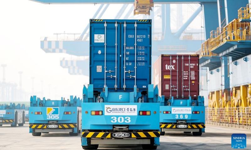 Automated guided vehicles transport containers at Qingdao Port, east China's Shandong Province, Dec. 27, 2023. Qingdao Port's automated terminal phase III project was put into operation on Wednesday, with two 100,000-metric-ton container berths.(Photo: Xinhua)
