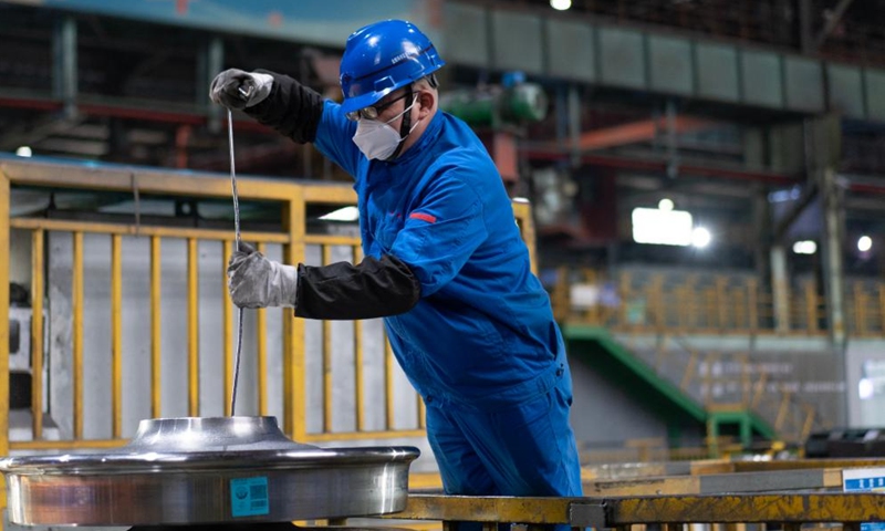 An employee packages a wheel product at a workshop in China Baowu Group Masteel Rail Transit Materials Technology Co., Ltd. (MRT) in Ma'anshan, east China's Anhui Province, Dec. 15, 2023. (Photo: Xinhua)