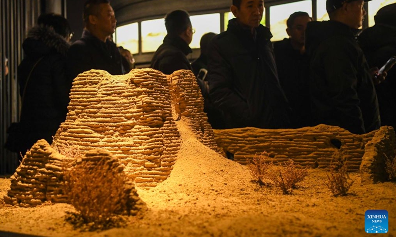 Tourists view the model of a beacon tower at the Silk Road and Great Wall Culture Museum in Yuli County, northwest China's Xinjiang Uygur Autonomous Region, Dec. 29, 2023. (Photo: Xinhua)