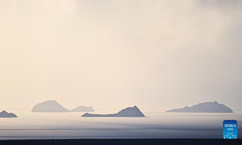 This photo taken on Dec. 18, 2023 shows the sunset scenery of Aqqik Kol Lake at the Altun Mountains National Nature Reserve in northwest China's Xinjiang Uygur Autonomous Region. The Altun Mountains National Nature Reserve is a representative of plateau desert ecosystem in China and is home to a wide variety of rare animals. (Photo: Xinhua)