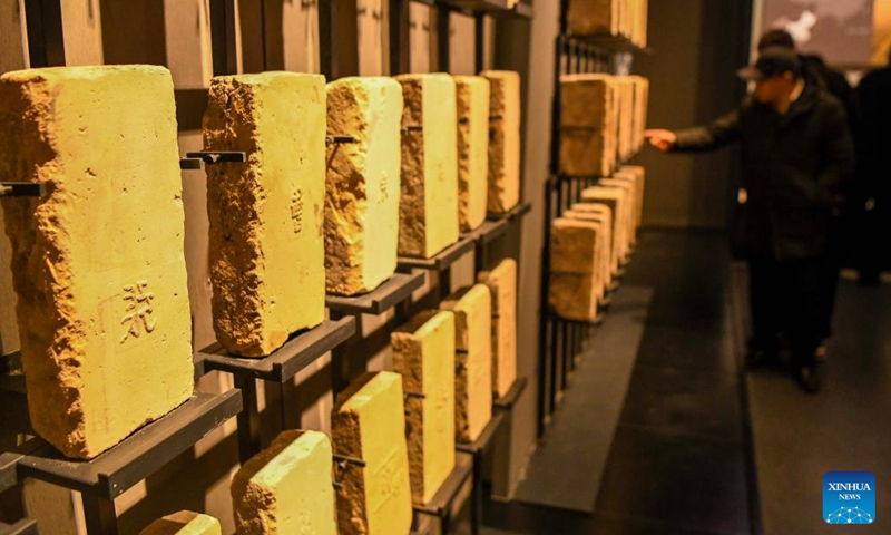 Tourists learn about the bricks for building the Great Wall at the Silk Road and Great Wall Culture Museum in Yuli County, northwest China's Xinjiang Uygur Autonomous Region, Dec. 29, 2023. (Photo: Xinhua)