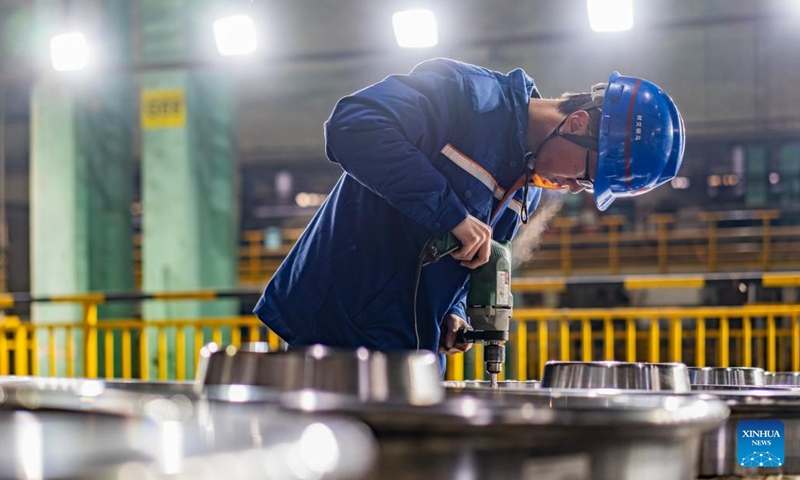 An employee grinds a wheel at a workshop in China Baowu Group Masteel Rail Transit Materials Technology Co., Ltd. (MRT) in Ma'anshan, east China's Anhui Province, Dec. 15, 2023. (Photo: Xinhua)