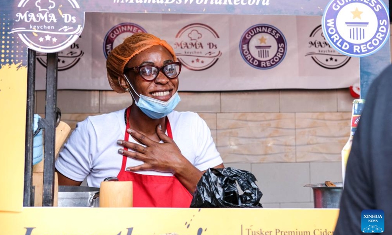 Dorcus Bashema Kirabo poses for a photo as she is set to break the Guinness world record for the longest cooking time by an individual in Kampala, the capital of Uganda, on Dec. 26, 2023. (Photo: Xinhua)