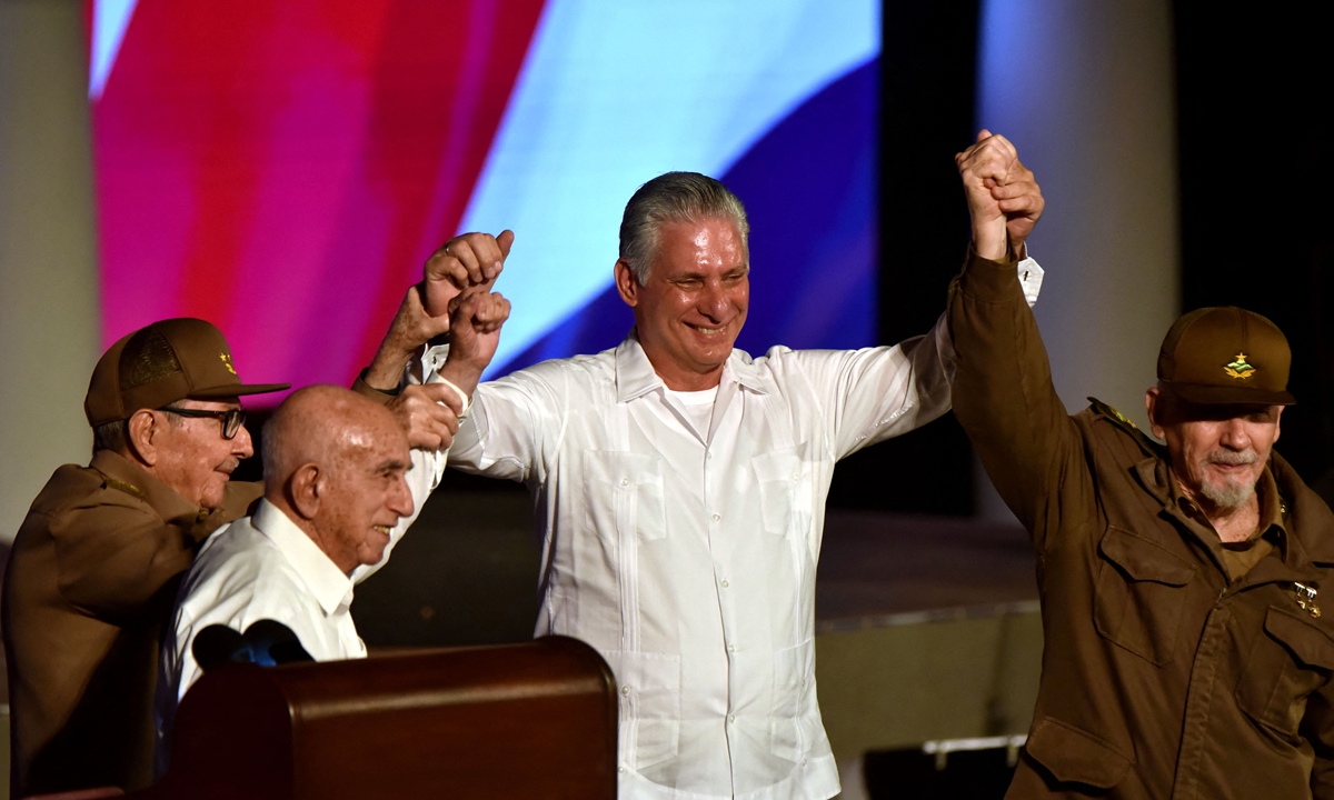 From left: former Cuban president Raul Castro, former vice president Jose Ramon Machado Ventura, incumbent Cuban President Miguel Diaz-Canel and Commander of the Revolution Ramiro Valdez Menendez raise their hands during a meeting to celebrate the 65th anniversary of the Cuban revolution in Santiago de Cuba on January 1, 2024. In his speech to close the event, Castro emphasized the need for unity and trust in the new generation of leaders. Photo: AFP
