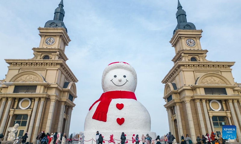 This aerial photo shows people visiting a giant snowman in Harbin, northeast China's Heilongjiang Province, Jan. 1, 2024. Heilongjiang Province has abundant ice-and-snow resources, making it a popular destination for winter tourism in China and attracting numerous tourists from home and abroad during the New Year holiday. (Photo:Xinhua)