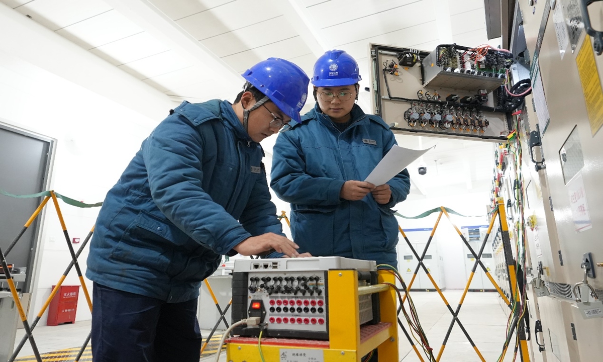 Workers from the State Grid Juxian County Power Supply Company debug equipment at the Fuan 110 kV Substation.