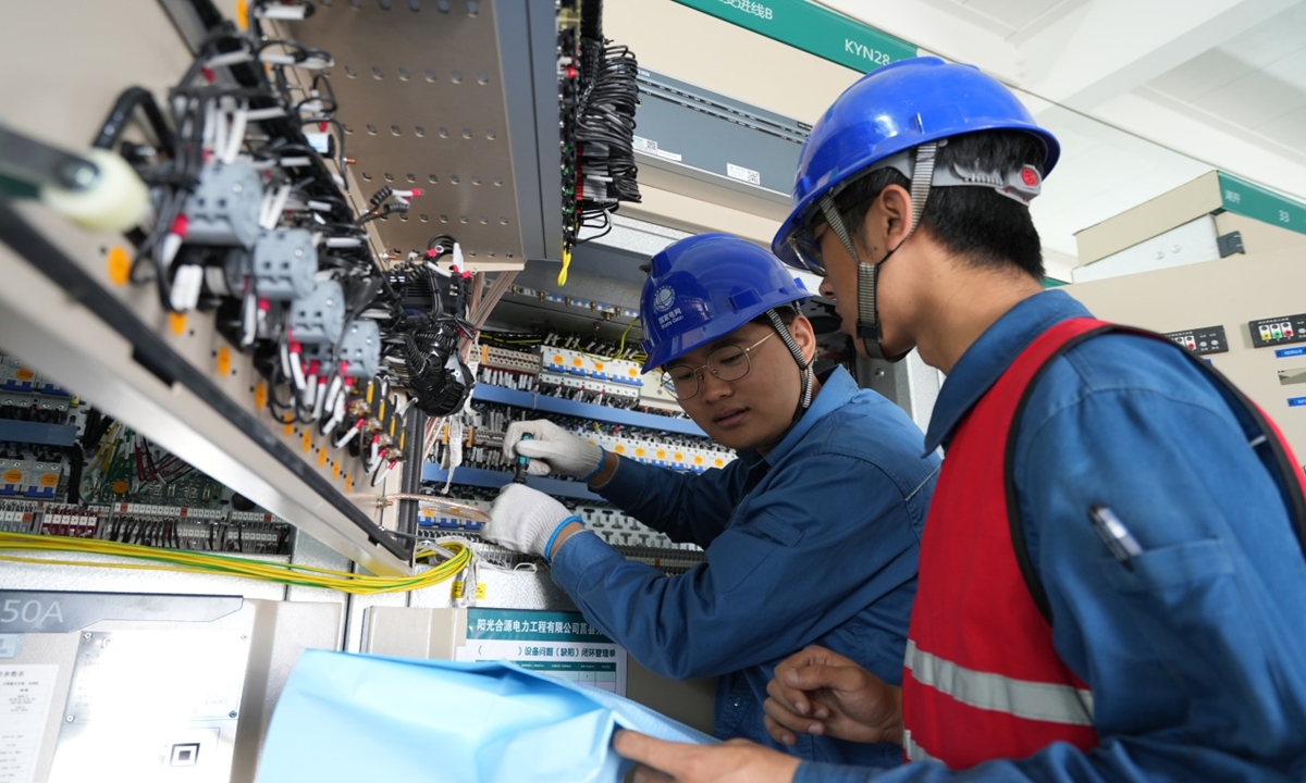 Workers from the State Grid Juxian County Power Supply Company debug equipment at the Fuan 110 kV Substation.