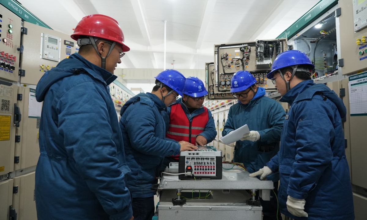 Workers from the State Grid Juxian County Power Supply Company debug equipment at the Fuan 110 kV Substation.