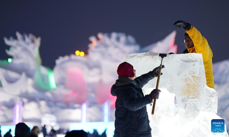 Competitors work on an ice sculpture during the 35th Harbin International Ice Sculpture Competition at Harbin Ice-Snow World in Harbin, northeast China's Heilongjiang Province, Jan. 2, 2024. The three-day competition kicked off here on Tuesday. (Photo: Xinhua)